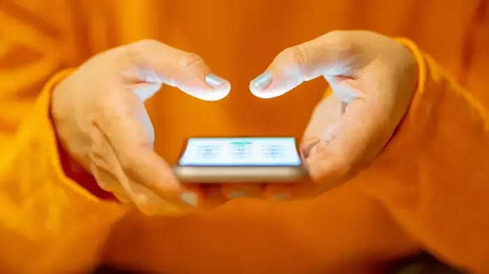 mujer leyendo un mensaje de pago en su celular